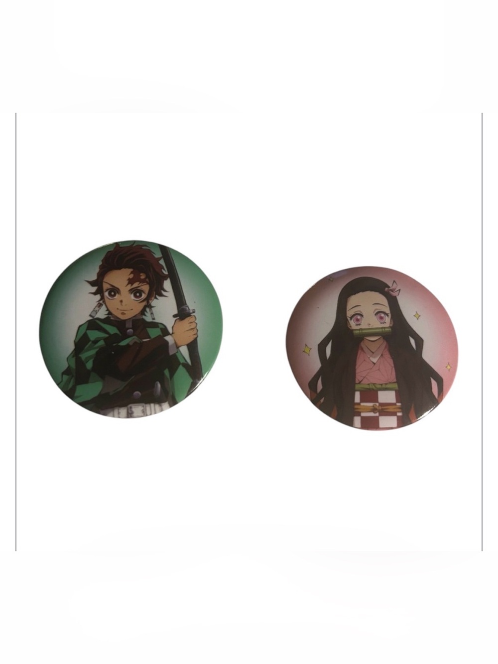 collectible button pins featuring Nezuko and Tanjiro Kamado